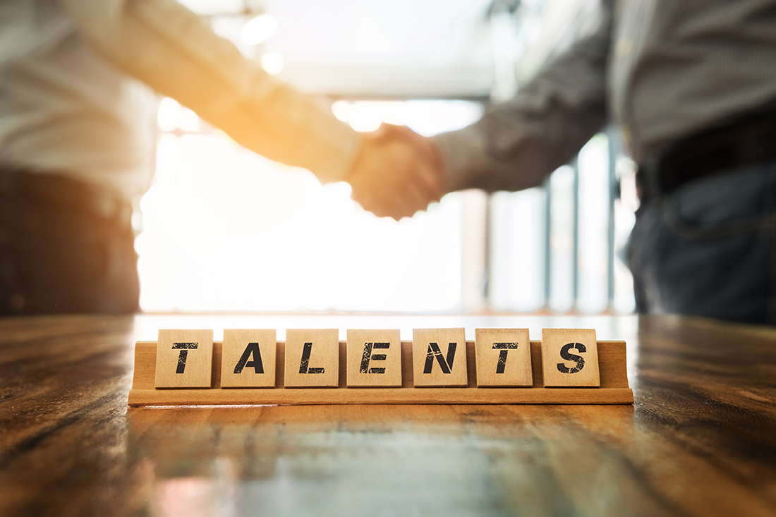 success word on wood table with business man shaking hands during a meeting in the office, dealing, greeting and partner concept background.