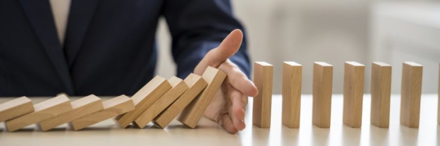Hand stopping falling blocks on table Hand stopping falling blocks on table