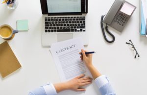 businesswoman signing contract document at office