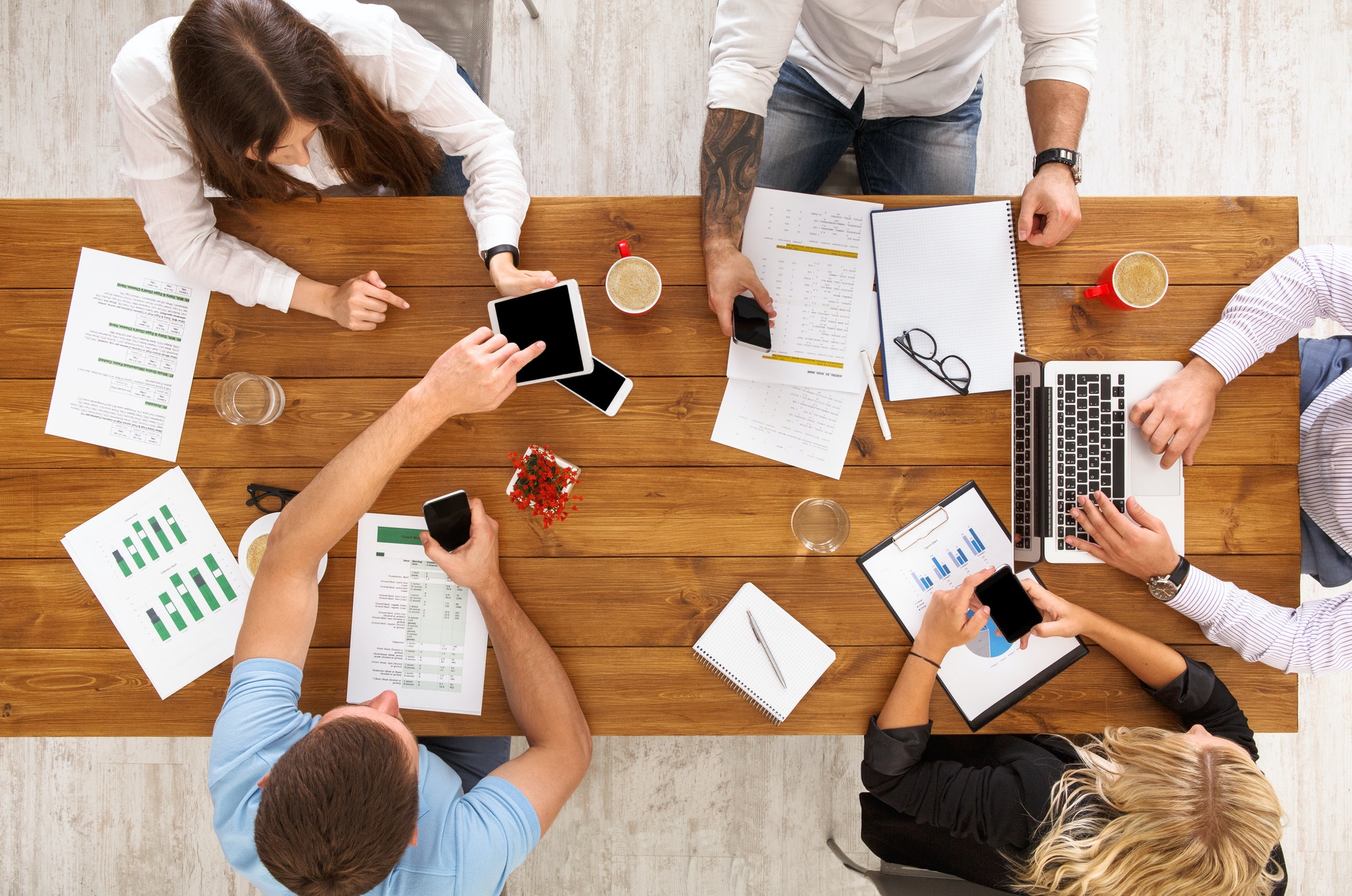 Group of busy business people working in office, top view