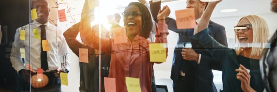 Ecstatic businesspeople celebrating success after an office brainstorming session Ecstatic businesspeople celebrating success after an office brainstorming session