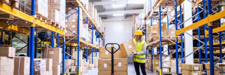 Female warehouse worker loading or unloading boxes. Female warehouse worker loading or unloading boxes.