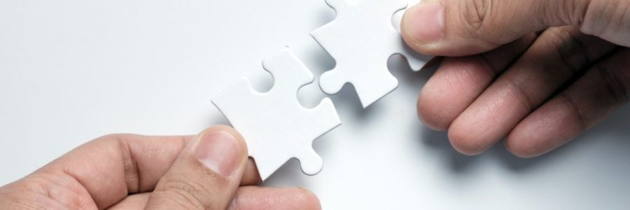 Partnership concept with hands putting puzzle pieces together Partnership concept with hands putting puzzle pieces together