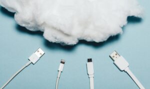 Four white wires laying under a white cotton cloud.
