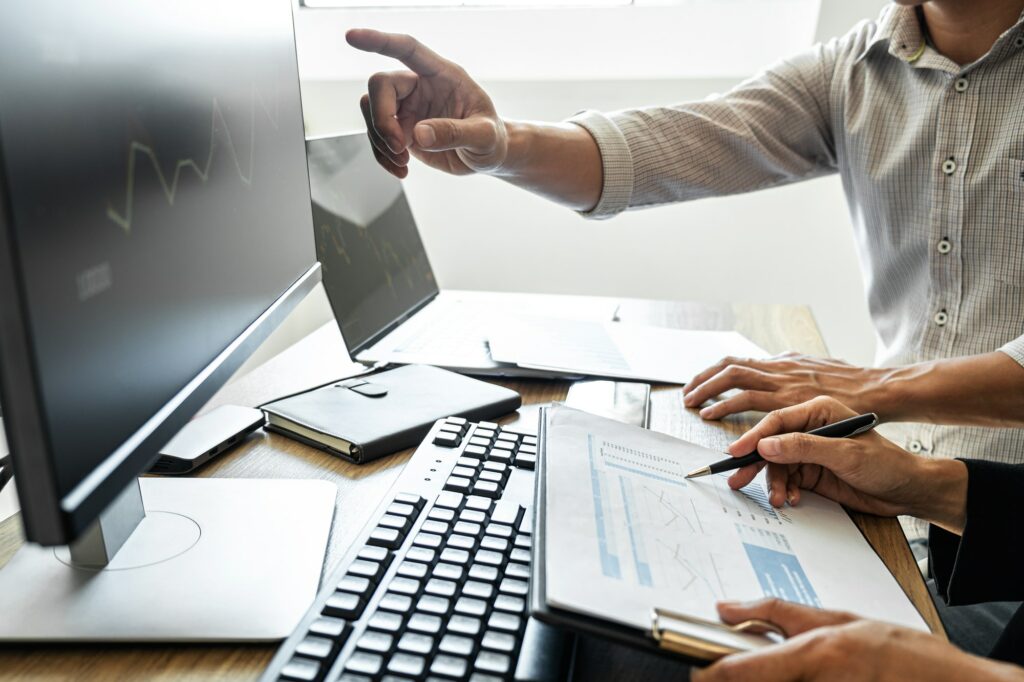 Business team investment working with computer, planning and analyzing graph stock market trading