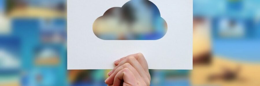 Female hand holding cloud perforated paper craft Female hand holding cloud perforated paper craft