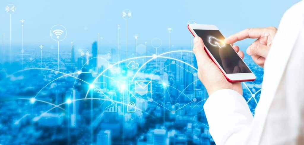 Man's hand using smartphone to connecting data information and blurred city background